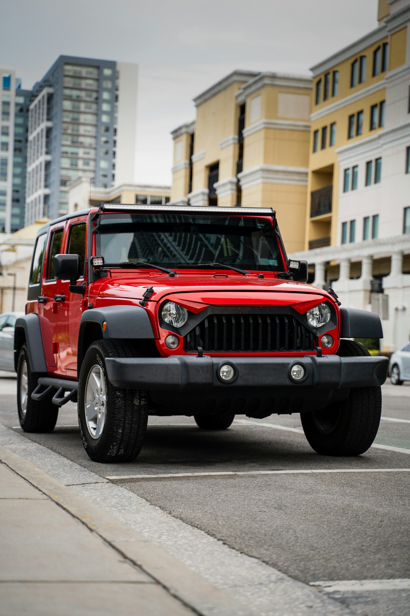 Red Jeep Wrangler with offroad upgrades